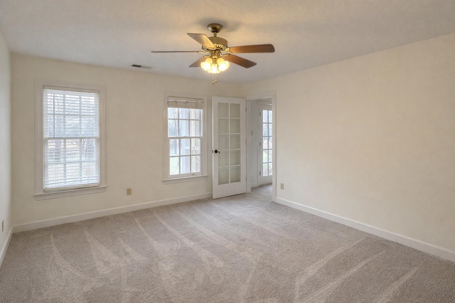 565 Schaeffer Loop Eads, TN 38028 - Photo 23 of 33 an empty room with chandelier fan and windows