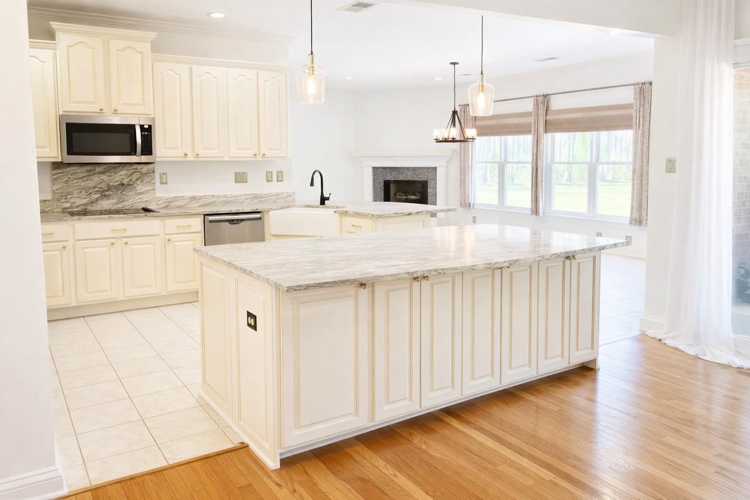 565 Schaeffer Loop Eads, TN 38028 - Photo 9 of 33 a kitchen with stainless steel appliances granite countertop a sink stove and white cabinets with wooden floor