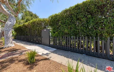 a view of a yard with wooden fence