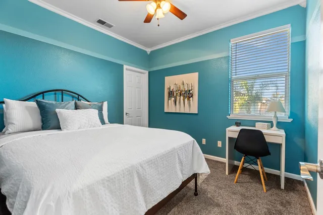 a bedroom with a bed and a window