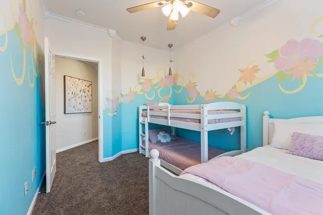 a bedroom with a bed and a chandelier