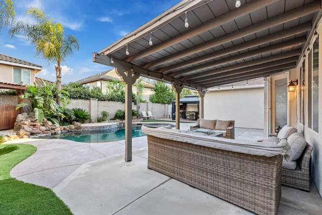 a house with swimming pool in front of it