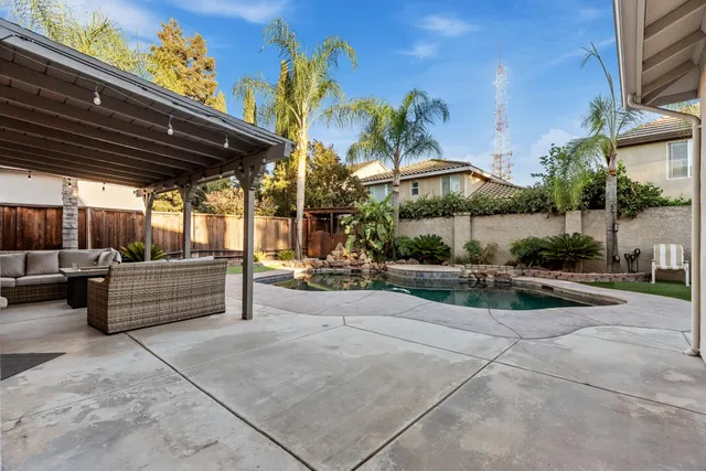 a swimming pool with outdoor seating yard and barbeque oven