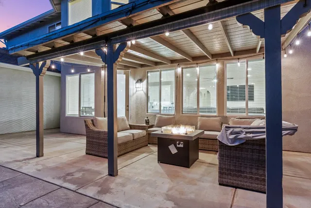 a swimming pool with outdoor seating and yard