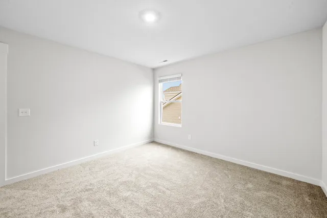 a view of an empty room and a window