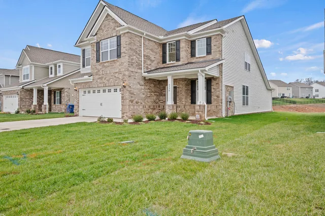 a front view of a house with a yard