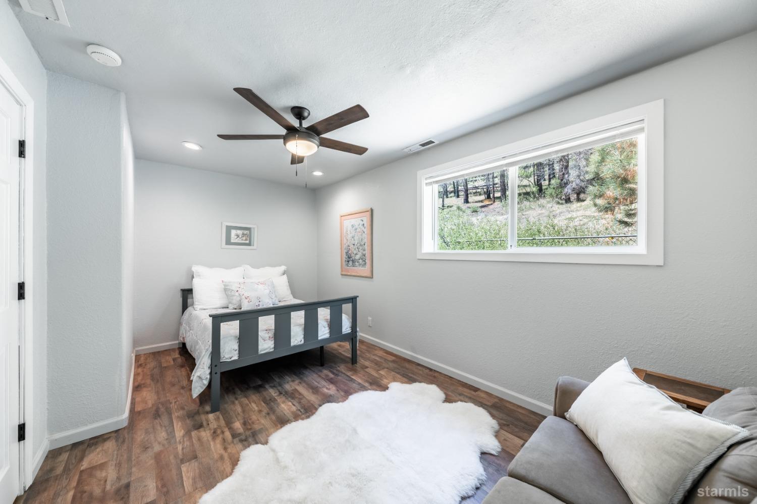 15740 Highway 89 Markleeville, CA 96120 - Photo 18 of 24 a bedroom with furniture and a window