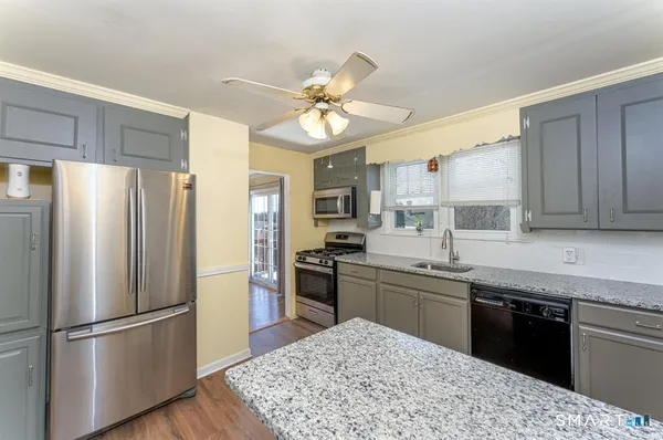 a kitchen with a stove a sink and a refrigerator