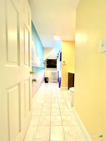 a bathroom with a tub sink and a mirror