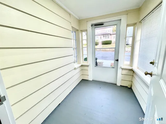 a bathroom with a bathtub and a window