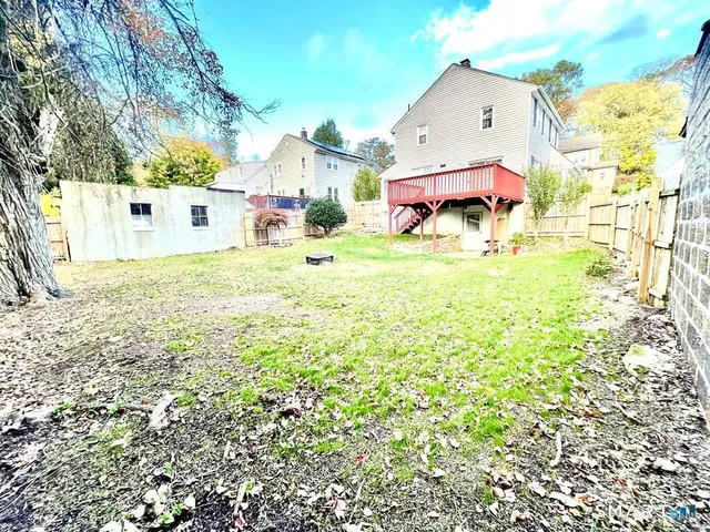 a backyard of a house with table and chairs