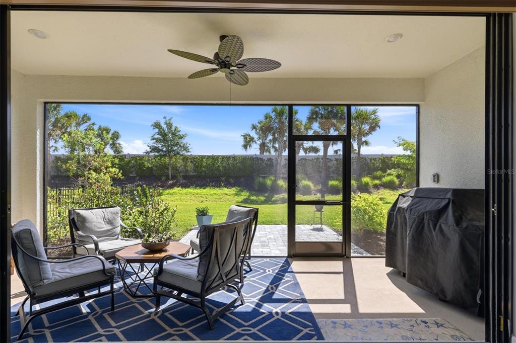 9268 Tequila Sunrise Drive Sarasota, FL 34241 - Photo 30 of 56 a view of a living room and floor to ceiling window and an outdoor view