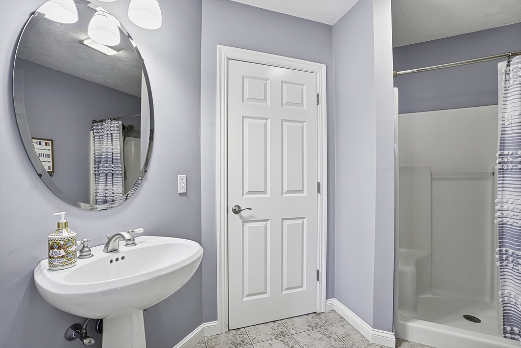 20 Thayer Road Mendon, MA 01756 - Photo 20 of 42 a bathroom with a sink a mirror and a shower