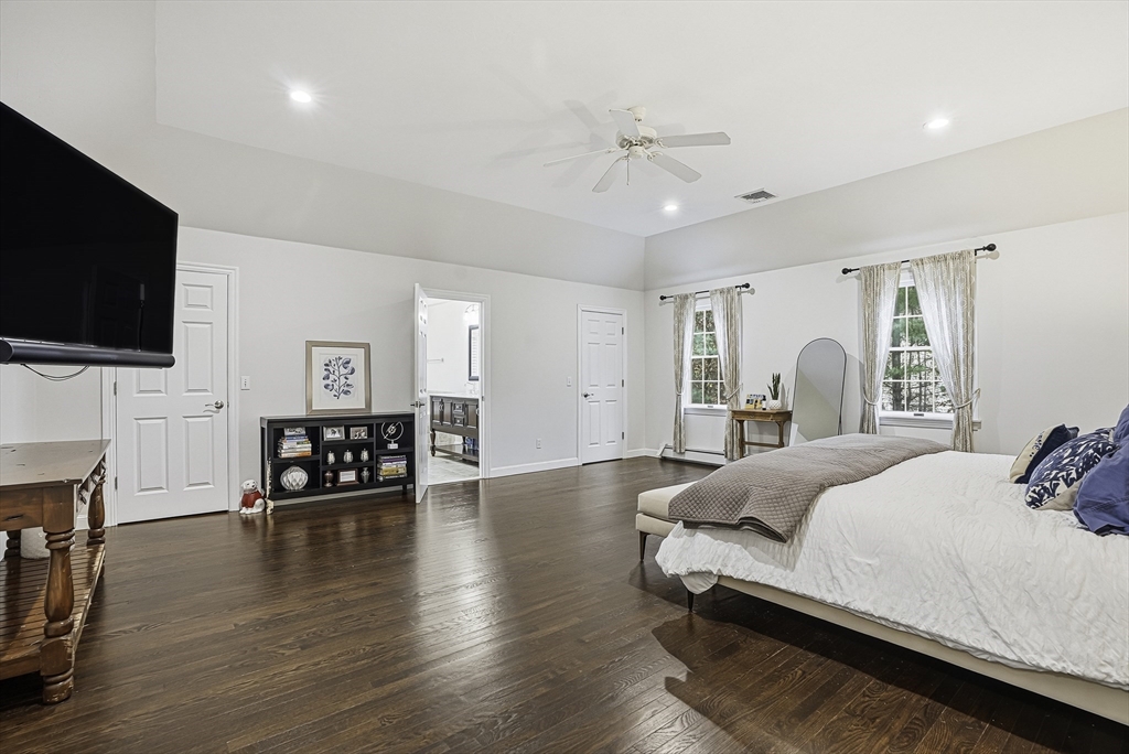 20 Thayer Road Mendon, MA 01756 - Photo 22 of 42 a spacious bedroom with a bed a couch and a flat screen tv