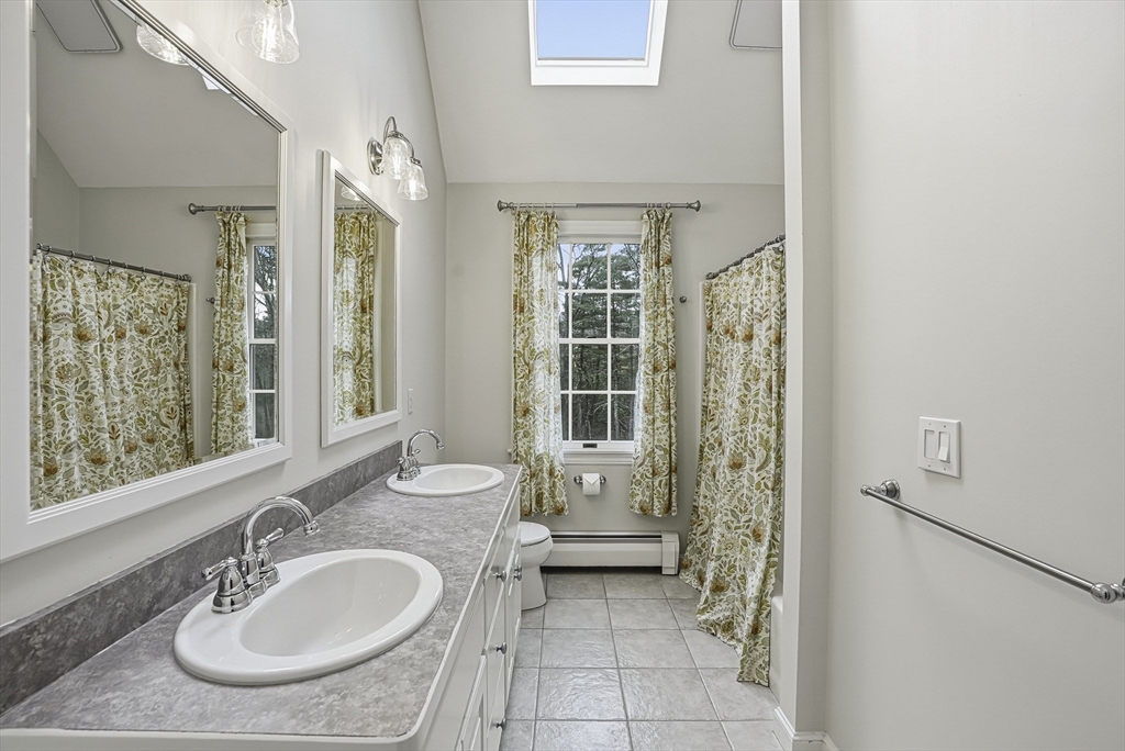 20 Thayer Road Mendon, MA 01756 - Photo 28 of 42 a bathroom with a granite countertop sink a mirror and a bathtub