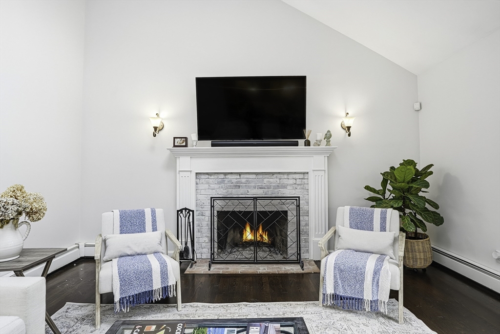 20 Thayer Road Mendon, MA 01756 - Photo 7 of 42 a living room with furniture a flat screen tv and a fireplace