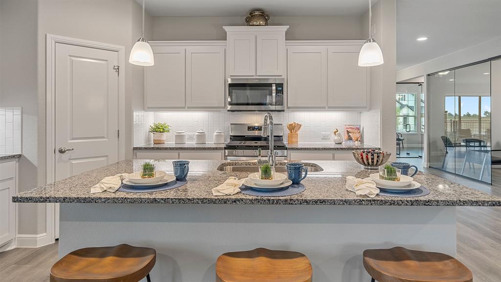 239 Windmill Drive Rhome, TX 76078 - Photo 28 of 30 Kitchen-All Home and community information, including pricing, included features, terms, availability and amenities, are subject to change at any time without notice or obligation. All Drawings, pictures, photographs, video, square footages, floor plans, elevations, features, colors and sizes are approximate for illustration purposes only and will vary from the homes as built.