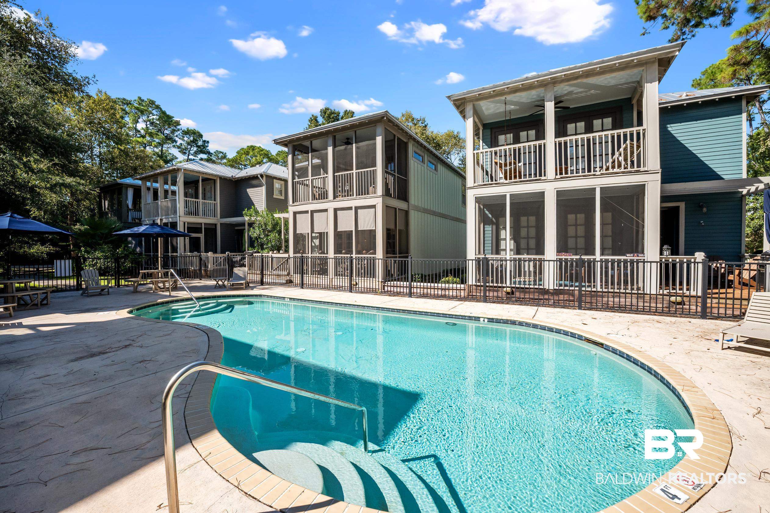 25773 Canal Road, Unit 28 Orange Beach, AL 36561 - Photo 38 of 48 Community pool with a patio, a sunroom, a ceiling fan, and a balcony