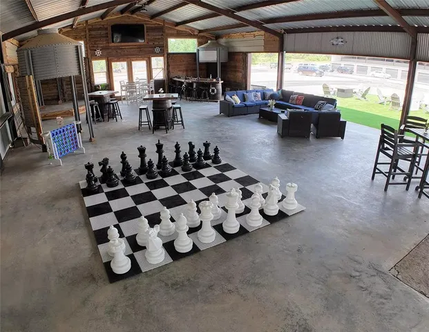 a room with lots of white furniture and a window