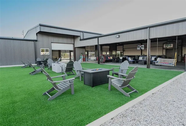 a view of a backyard with sitting area and garden
