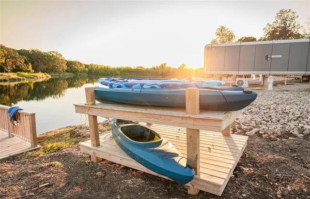 a view of a terrace with wooden floor and lake view