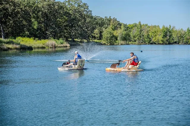 a backyard of a house with lots of green space and fountain