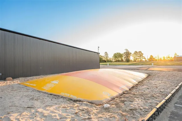 a view of a swimming pool with a yard and sitting area