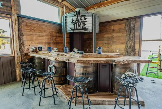 a view of a backyard with couches under an umbrella
