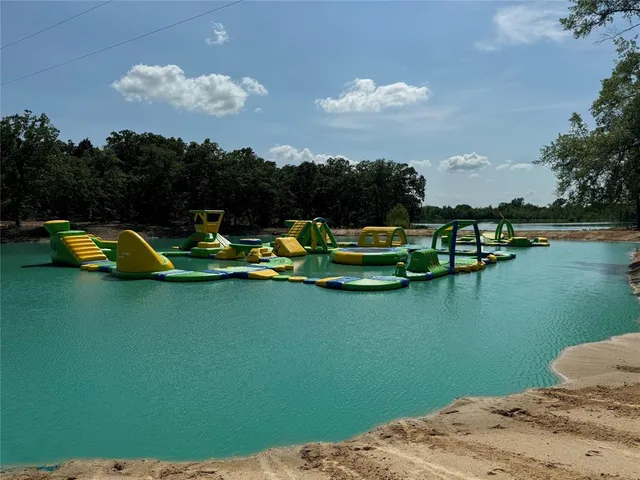 a view of a lake with lawn chairs