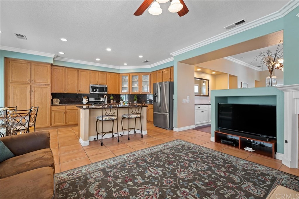 20803 Millbrook Street Riverside, CA 92508 - Photo 11 of 44 a living room with furniture a flat screen tv and kitchen view