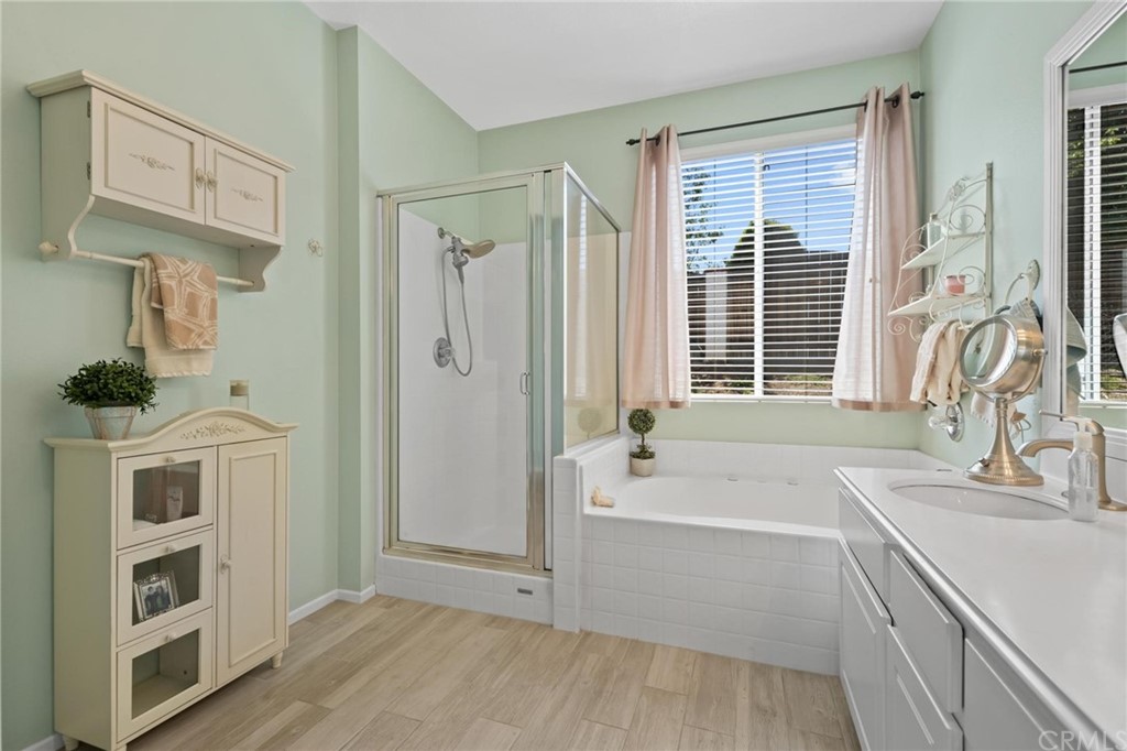 20803 Millbrook Street Riverside, CA 92508 - Photo 23 of 44 a bathroom with a tub sink and mirror