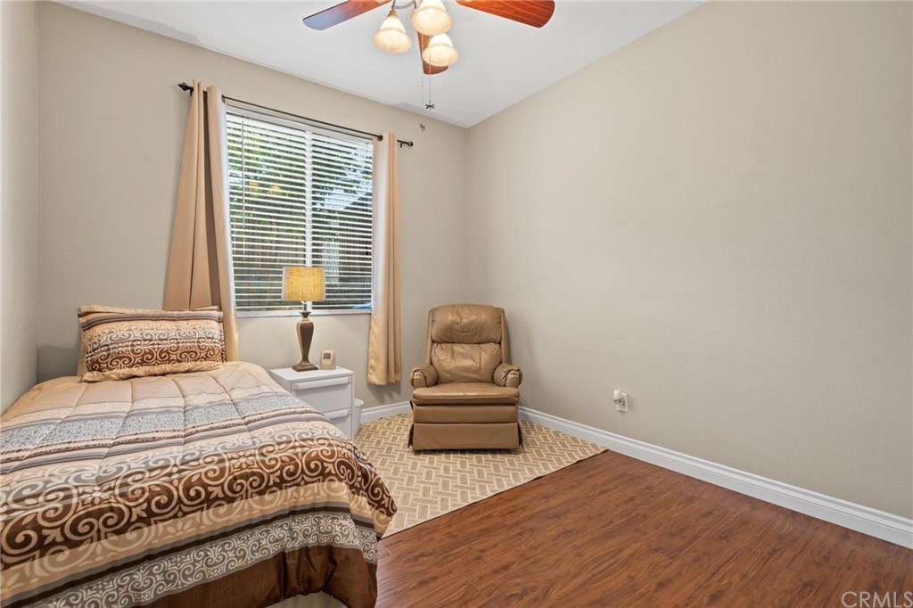 20803 Millbrook Street Riverside, CA 92508 - Photo 28 of 44 a bedroom with a bed and a chandelier