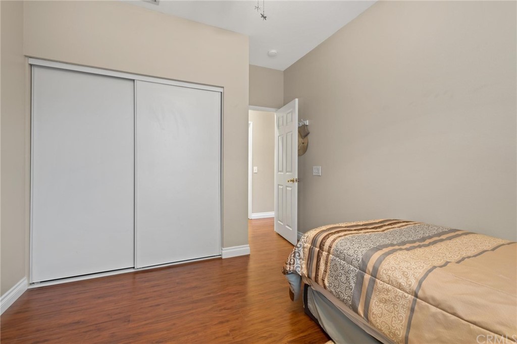 20803 Millbrook Street Riverside, CA 92508 - Photo 29 of 44 a bedroom with a bed and wooden floor