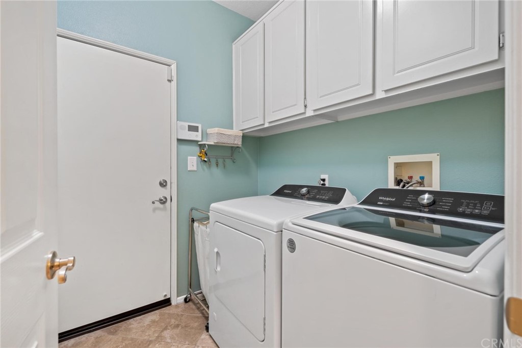 20803 Millbrook Street Riverside, CA 92508 - Photo 30 of 44 a view of storage and utility room with washer and dryer