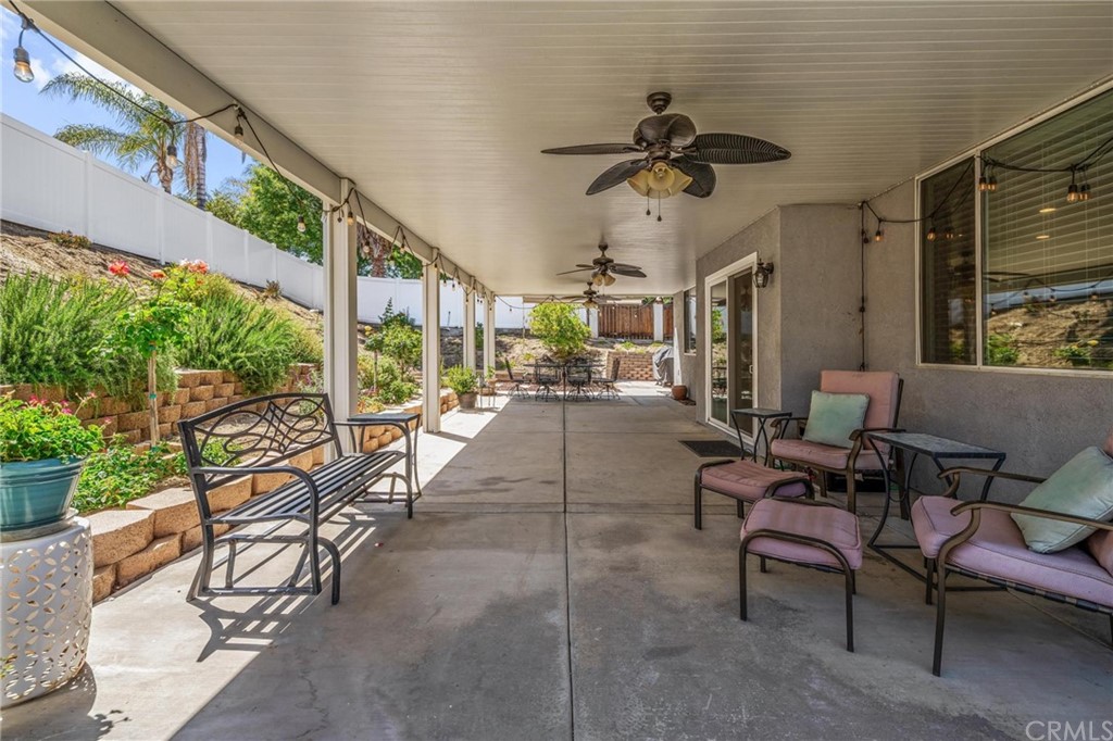 20803 Millbrook Street Riverside, CA 92508 - Photo 38 of 44 a living room with patio furniture and a floor to ceiling window