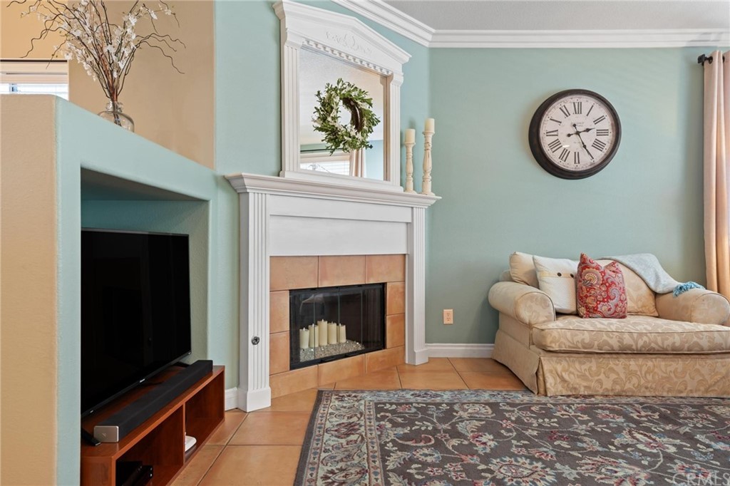 20803 Millbrook Street Riverside, CA 92508 - Photo 10 of 44 a living room with a couch a clock and a fireplace