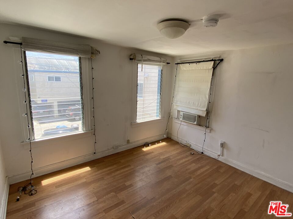 44 Rose Avenue Venice, CA 90291 - Photo 23 of 33 a view of an empty room with a window and wooden floor