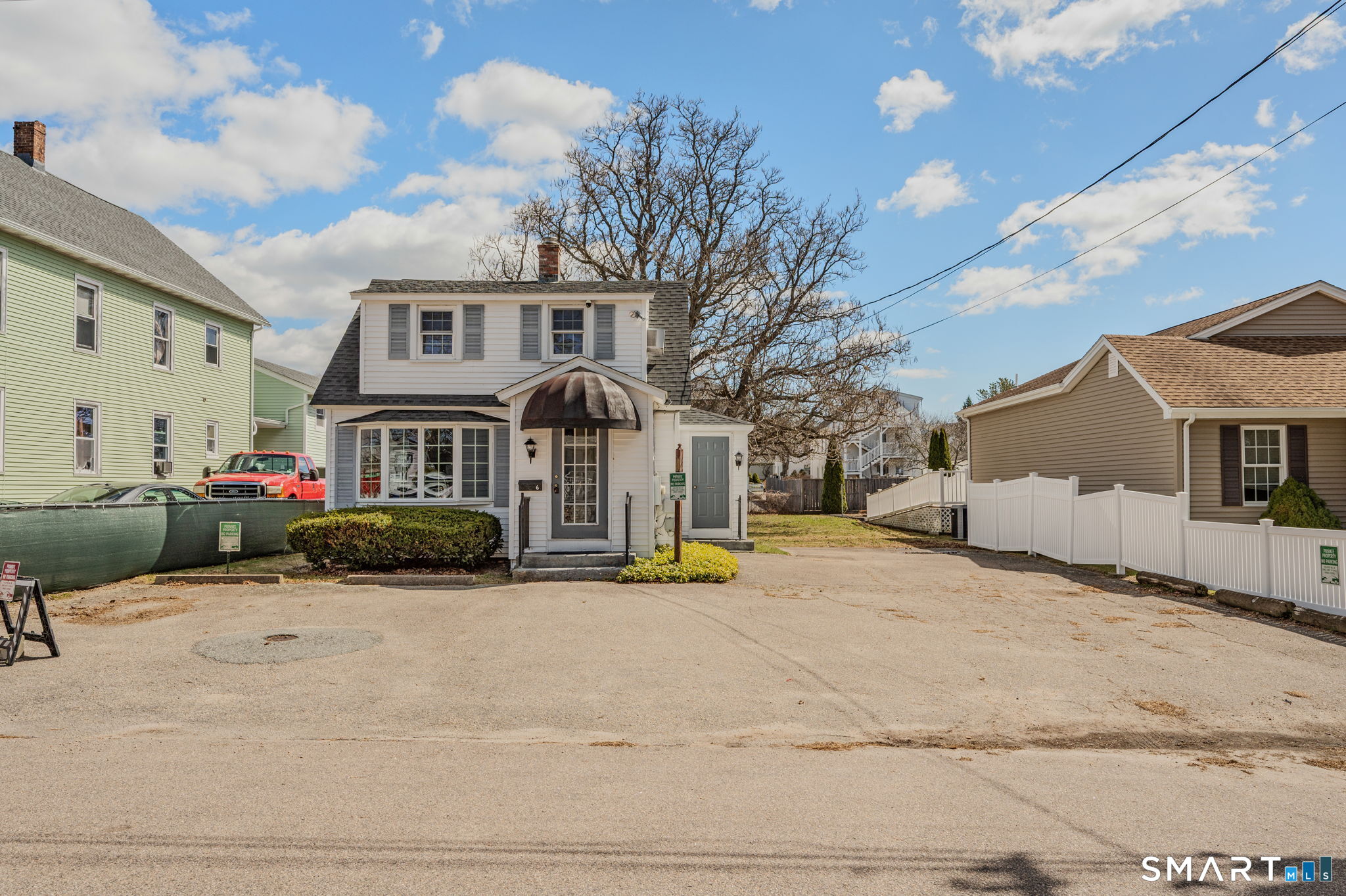 6 Hatch Street Stonington, CT 06355 - Photo 3 of 26 a view of a white house with a yard and sitting area