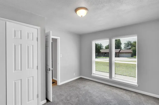 an empty room with windows and entrance