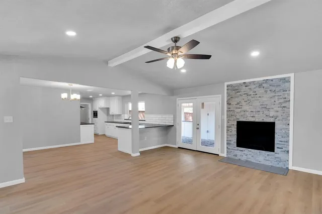 a view of a kitchen with a fireplace a sink and dishwasher