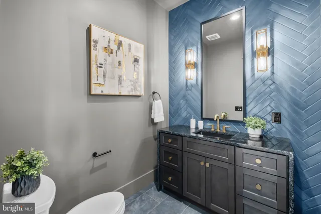 a kitchen with a stove a sink and chairs