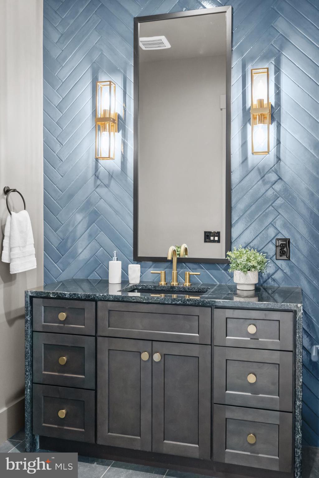 1852 Griffith Road Falls Church, VA 22043 - Photo 17 of 110 a bathroom with a granite countertop sink and a mirror