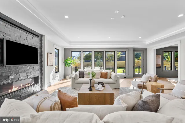 a bedroom with a large bed couch and a large window