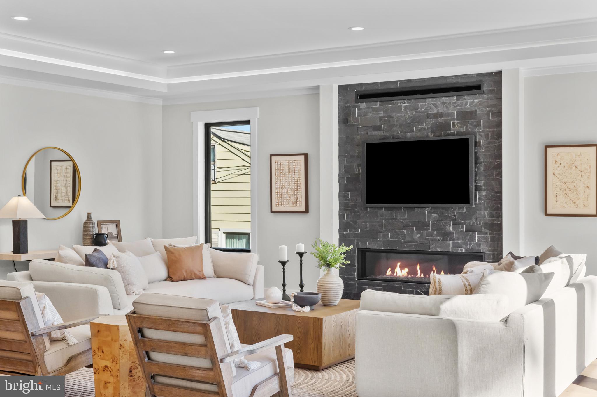 1852 Griffith Road Falls Church, VA 22043 - Photo 36 of 110 a living room with furniture a fireplace and a flat screen tv