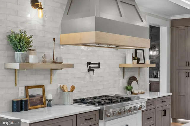 a kitchen with stainless steel appliances granite countertop a refrigerator and a stove