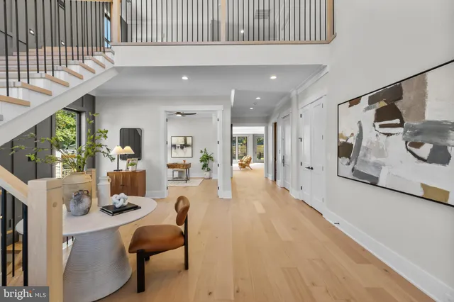 a living room with furniture flat screen tv and a large window