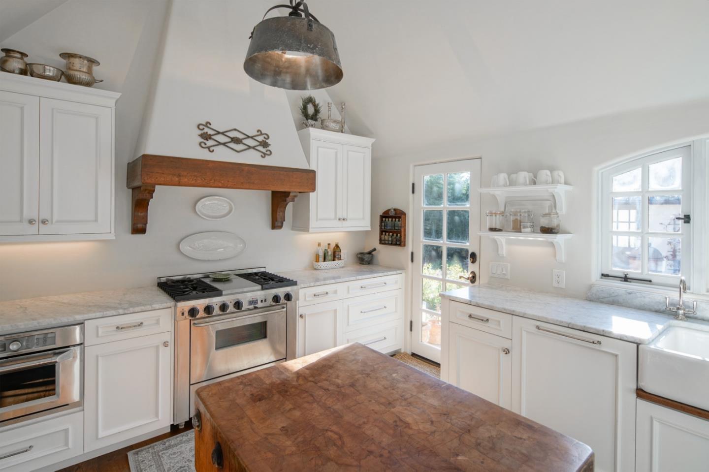 25148 Hatton Road Carmel, CA 93923 - Photo 15 of 33 a kitchen with a stove cabinets and window