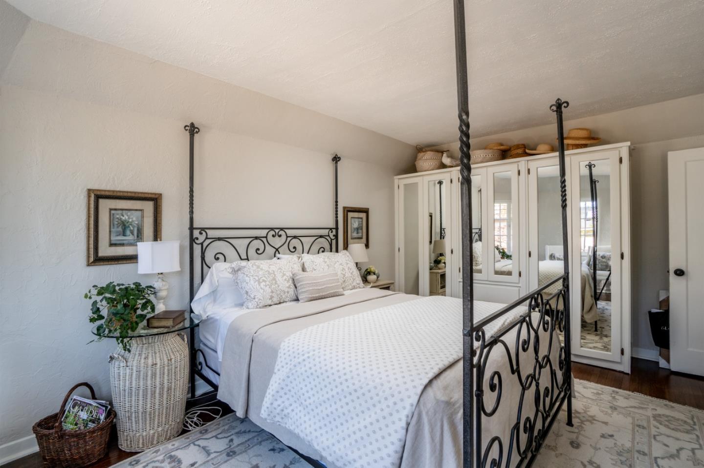 25148 Hatton Road Carmel, CA 93923 - Photo 19 of 33 a bedroom with a bed table and a potted plant