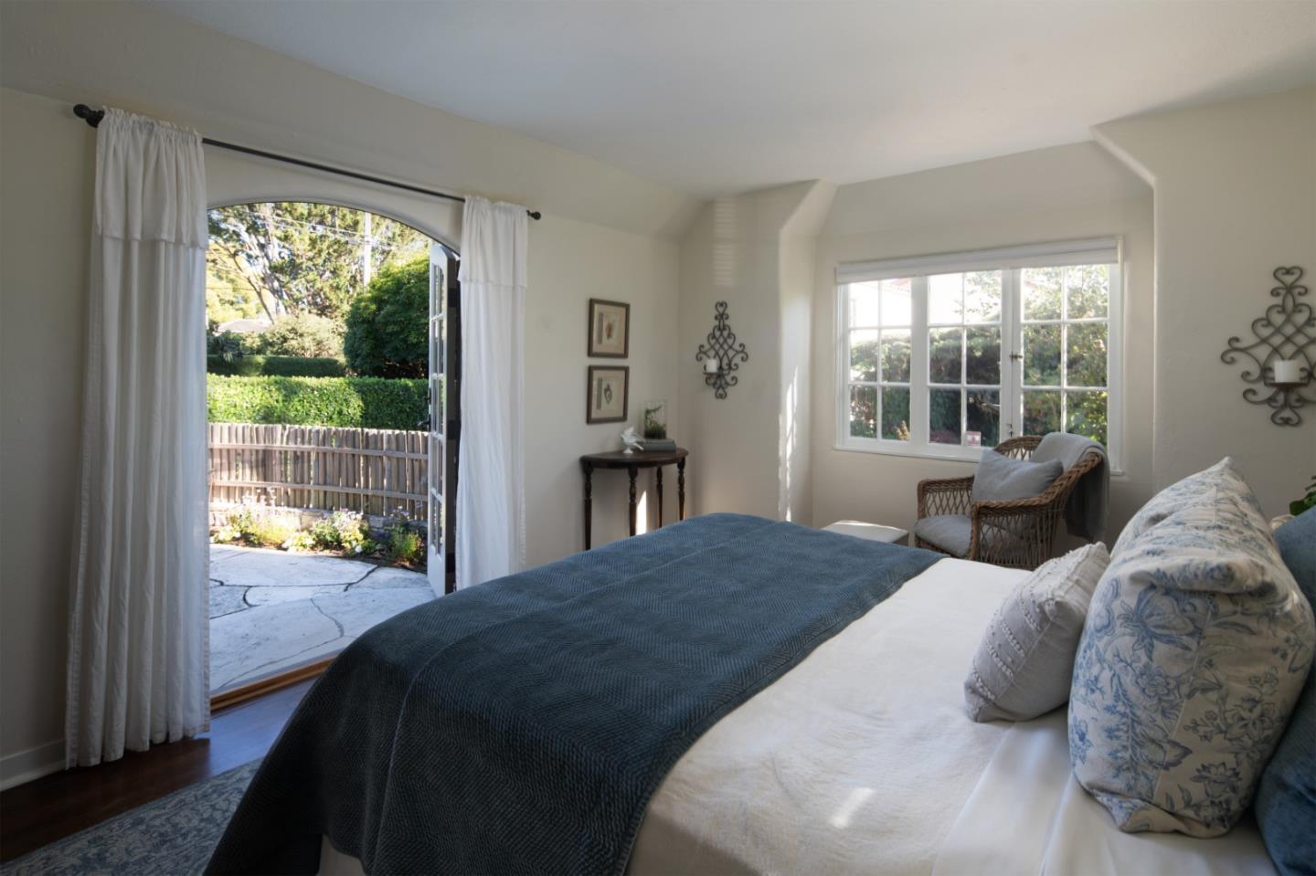 25148 Hatton Road Carmel, CA 93923 - Photo 22 of 33 a bedroom with a bed and glass window