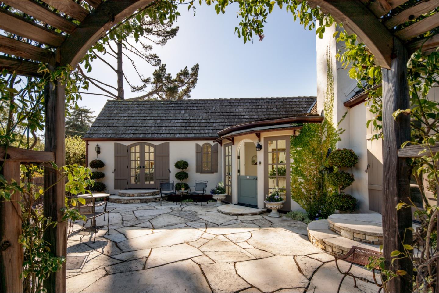 25148 Hatton Road Carmel, CA 93923 - Photo 3 of 33 a wooden bench sitting in front of a building